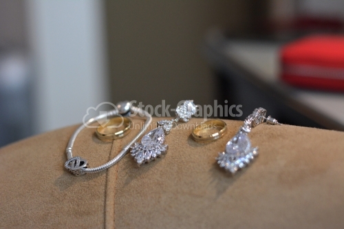The groom's wedding rings and the bride's jewelry.