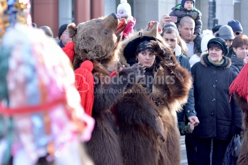 The young girl play the bear on the street. New Year's popular dance.