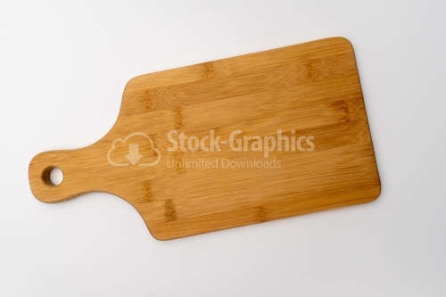 Top view of wooden cutting board on white table