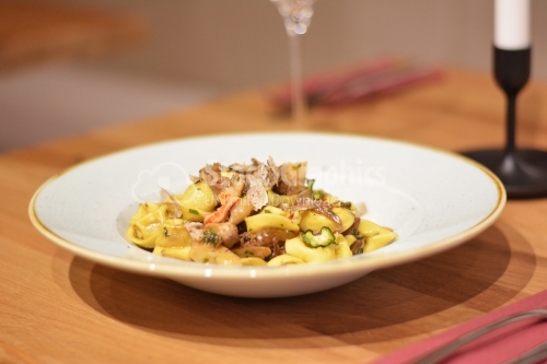 Tortellini pasta with pork and dehydrated vegetables.