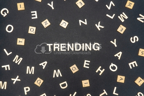 TRENDING word written on dark paper background. TRENDING text for your concepts