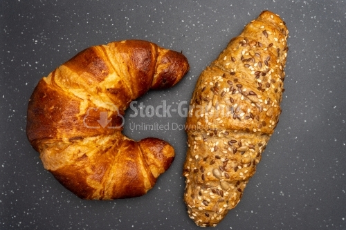 Two different croisants on a dark background