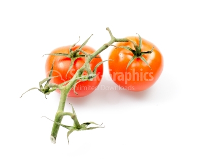 Two fresh tomatoes with green leaves isolated on white backgroun
