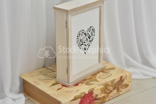 Vertical wooden box with perforated heart-shaped front