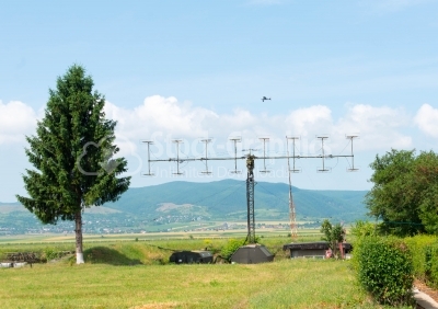 View of green grass with army antennas