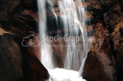 Waterfall on river in red mountains