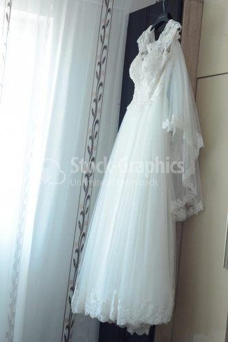 Wedding dress hanging from furniture.