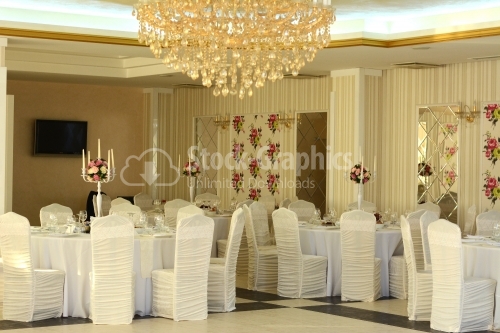 Wedding room with lots of tables and chairs