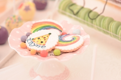 White cookies with colorful drawings; Rainbows and clown hats drawings