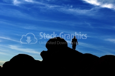 Woman / man hiking silhouette in mountains