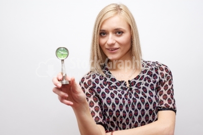 Woman holding clock - Stock Image