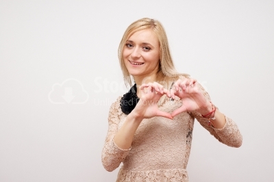 Woman showing hands heart on a white background
