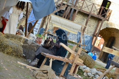 Woman weaving silk in traditional way at manual loom