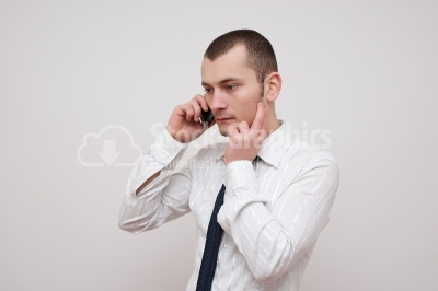 Worried Young businessman talking with the phone