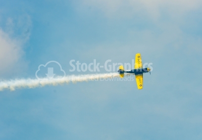 Yellow propeller plane flying