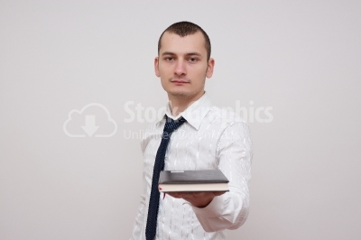 Young businessman sharing his notebook with you