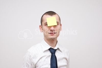 Young businessman with a post it on his head