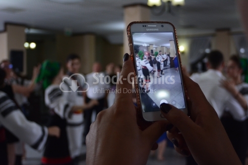 Young girl taking a photo on a wedding