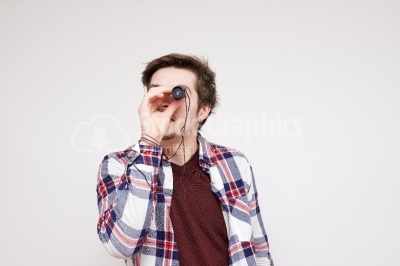 Young guy looking through a binocular