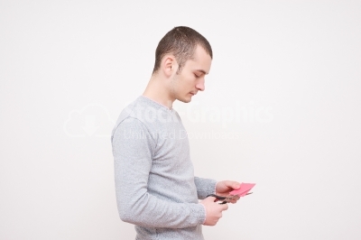 Young man cutting paper