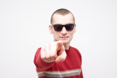 Young man pointing finger towards you and to the camera