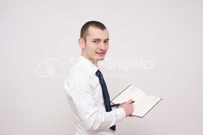 Young man writing on a notebook