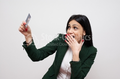 Young smiling business woman holding credit card isolated on whi