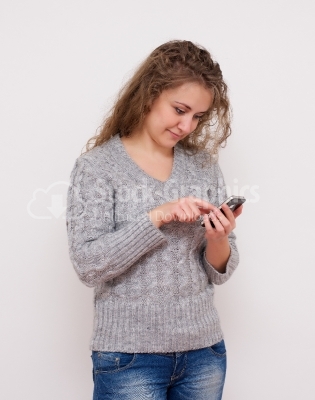 Young woman typing message in smart phone