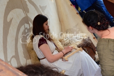Young woman working on a ancient hand loom